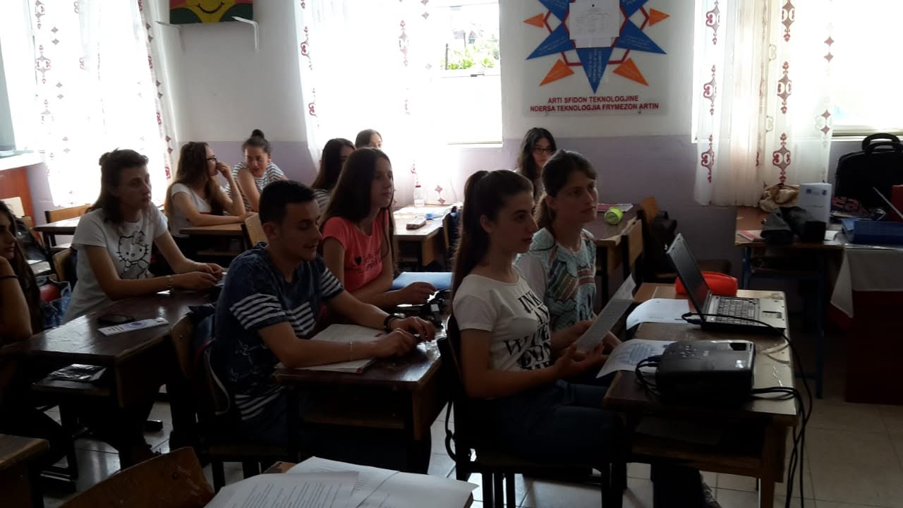 Participants seated in a classroom listening to a presentation