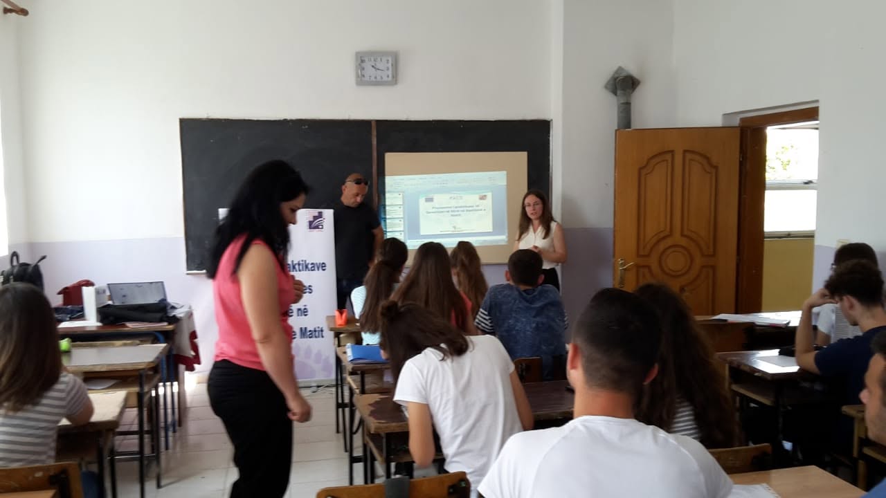 Presenters speaking to students in a classroom during an information session